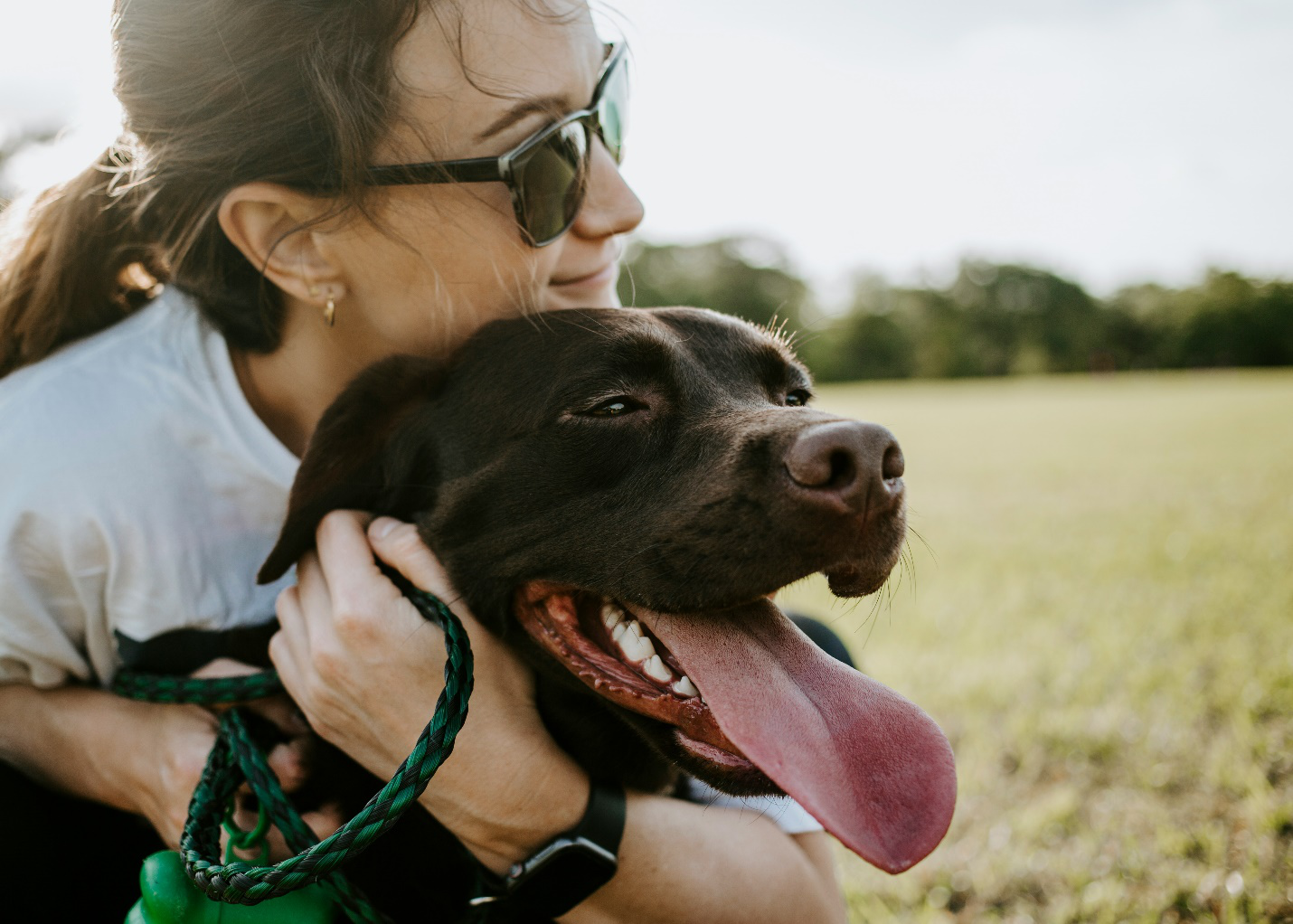 A woman hugging her dog.