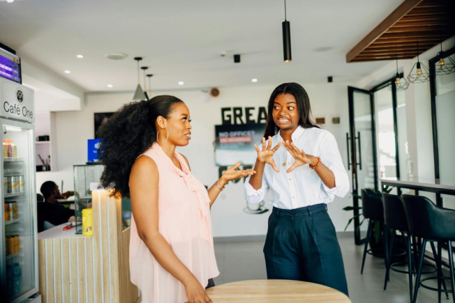 A pet parent discussing their dog's dietary needs with a staff member. File Name: Women-talking