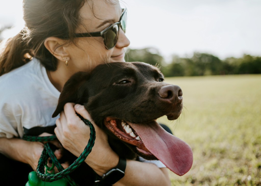 a pet owner sitting with their dog