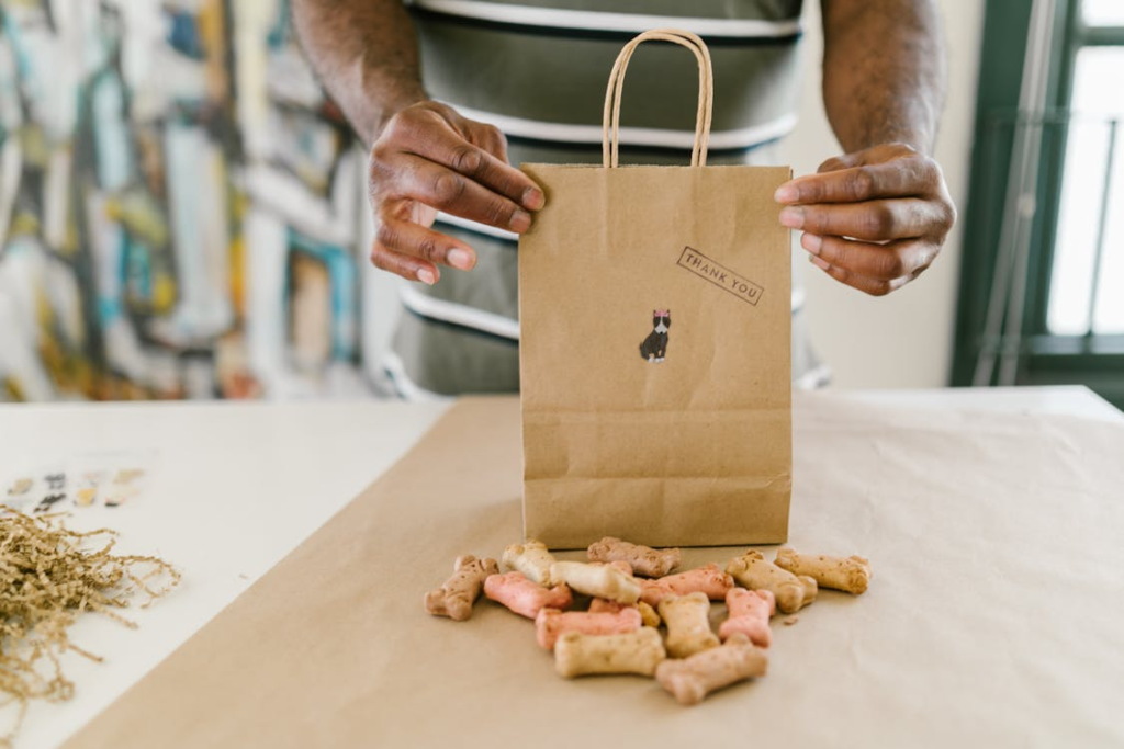 A pet owner packing a bag with dog toys and supplies